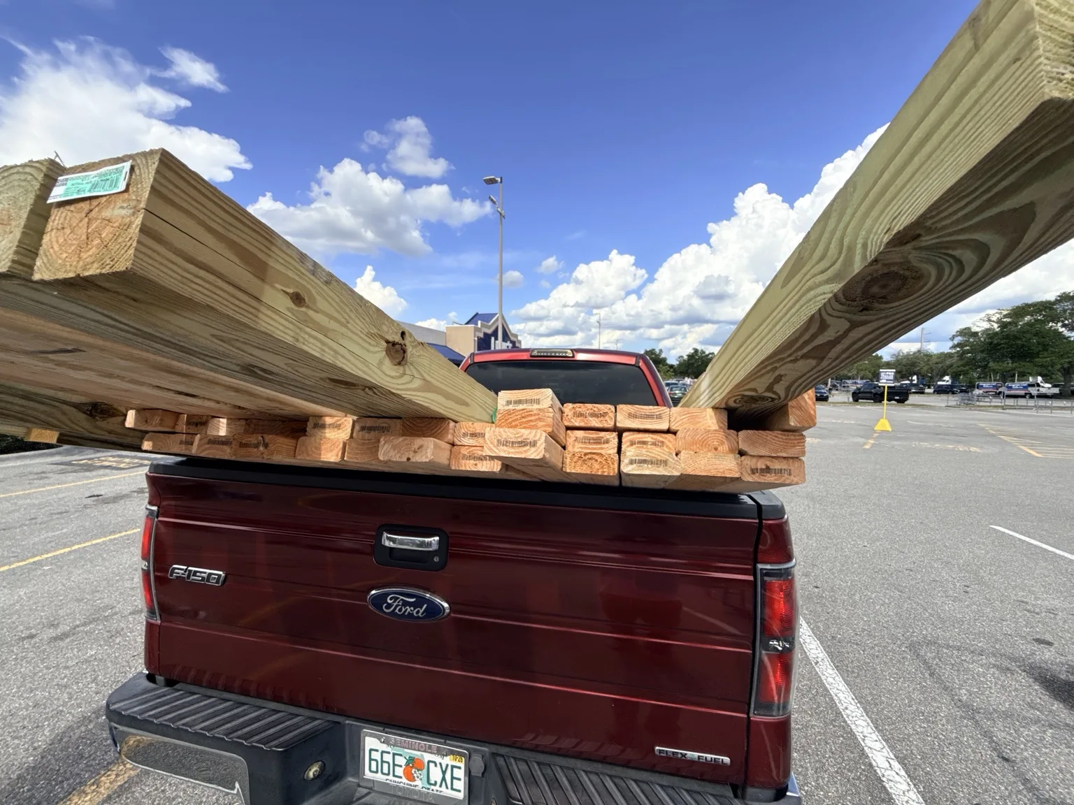 Pickup truck carrying lumber for a construction project