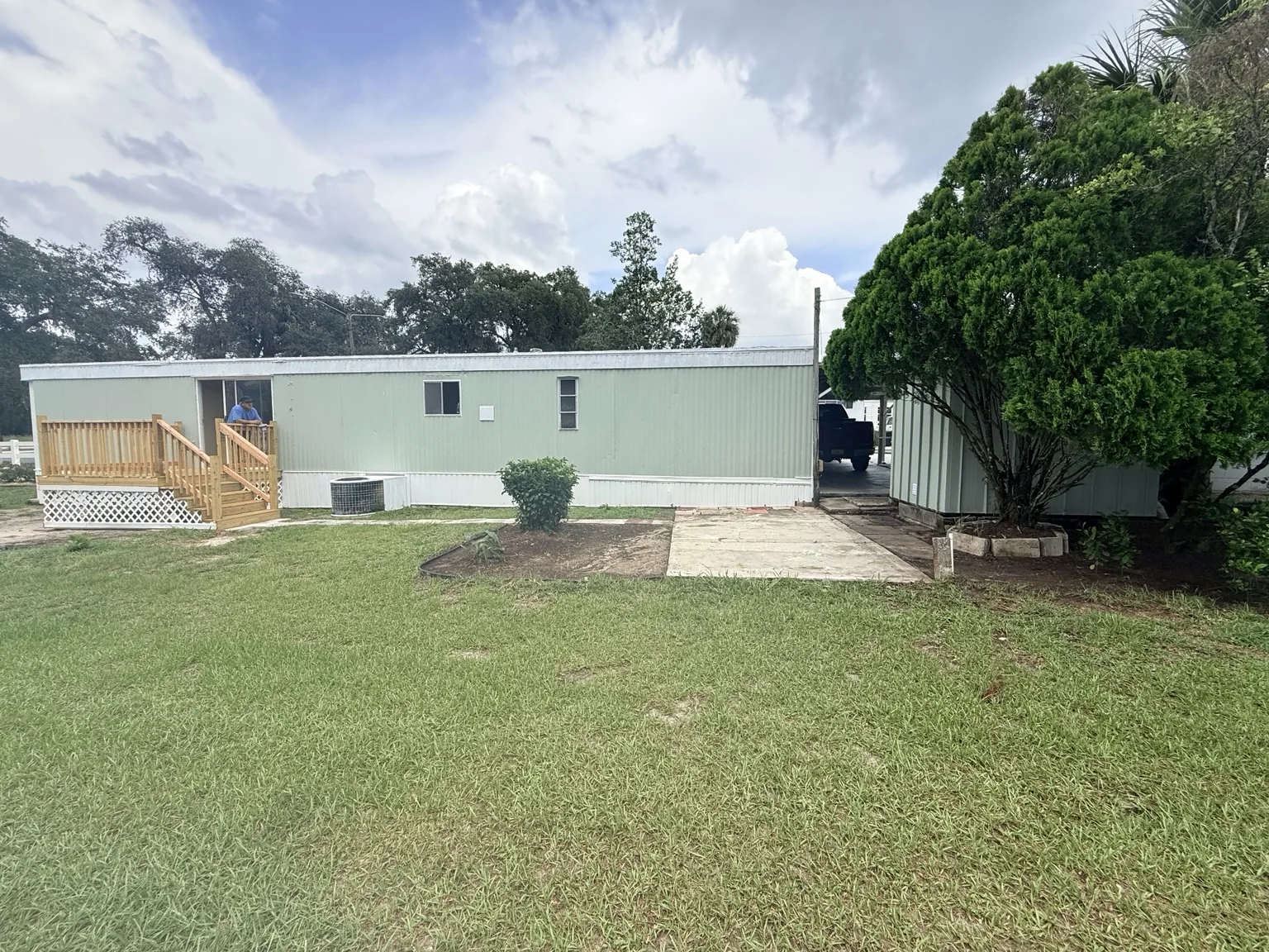 Residential mobile home with completed wooden deck and steps